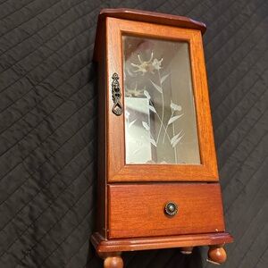 Vintage wooden jewelry box with glass door.